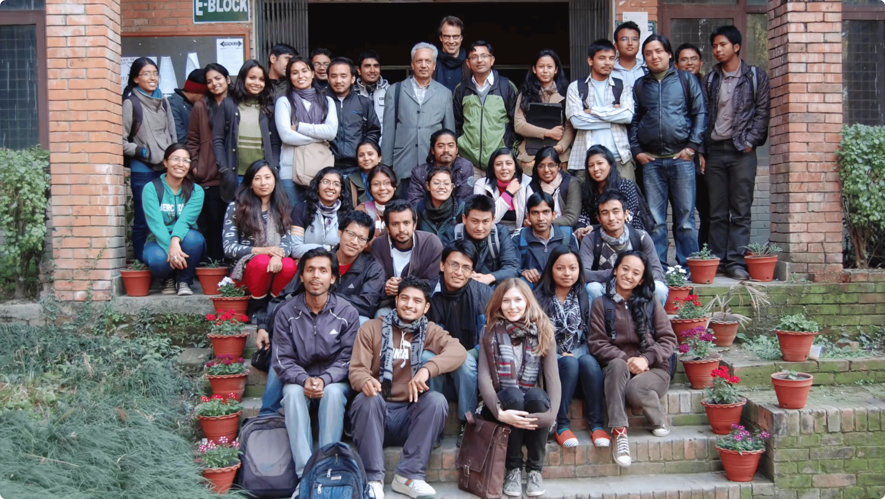 A group of people posing on stairs after completing a mapping workshop